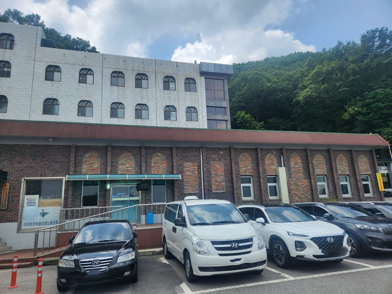 안양메트로병원장례식장 주차장 앞 벽돌 외관 주차장 너머로 보이는 장례식장 외관.